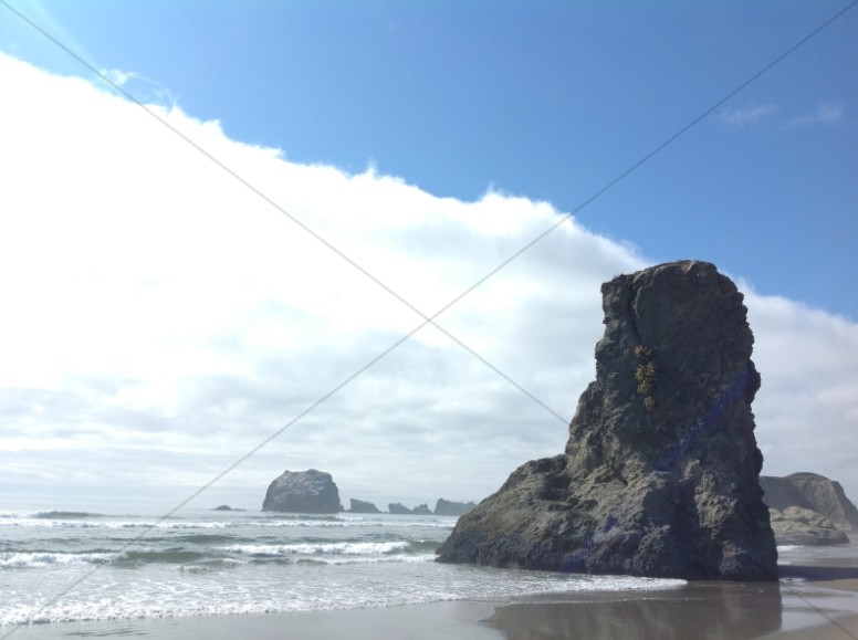 Large Rock on Beach Scene Religious Stock Photo