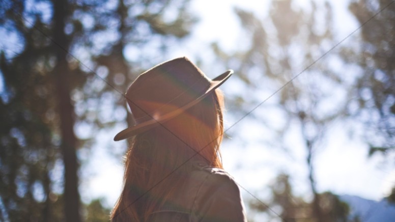 Girl in Fedora Staring at the Sun Christian Stock Photo